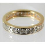 A yellow metal diamond eternity ring set with appr