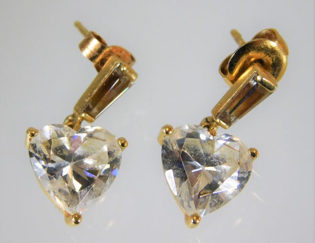 A yellow metal pair of earrings set with paste sto