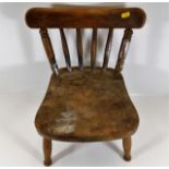 A small 19thC. elm childs chair