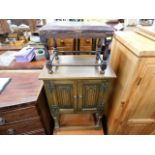 A small oak Old Charm style cupboard twinned with