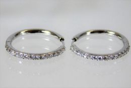 An 18ct white gold pair of earrings set with diamo