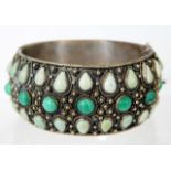 A Chinese white metal bangle set with malachite &