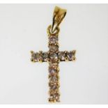 An 18ct gold cross set with diamonds of 0.25ct 1g
