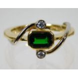 An 18ct gold ring set with green garnet & diamonds