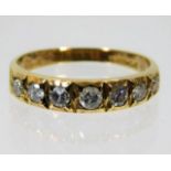 An 18ct gold ring set with seven diamonds of appro