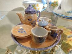 A miniature Japanese lusterware tea for two dolls