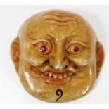 A carved Oriental mask