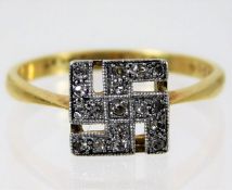 An early 20thC. 18ct gold ring set with diamond em