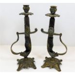 A pair of c.1900 lion head handle sword candlestic