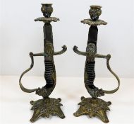 A pair of c.1900 lion head handle sword candlestic