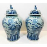 A large pair of decorative Chinese lidded urns
