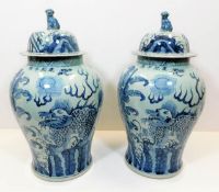 A large pair of decorative Chinese lidded urns