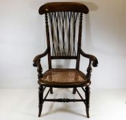 A c.1900 armchair with cane seat & twist stick bac