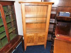 A Peter Bromfield glazed display cabinet with cupb