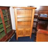 A Peter Bromfield glazed display cabinet with cupb