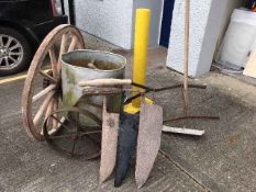 A wagon wheel twinned with a two handled saw & far