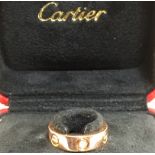 An 18ct rose gold Cartier Love ring set with three diamonds size M/N 8g