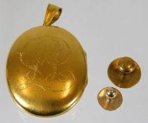 A yellow metal locket, tests at 18ct gold, with inscription twinned with a 15ct gold topped collar s