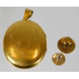 A yellow metal locket, tests at 18ct gold, with inscription twinned with a 15ct gold topped collar s