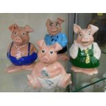 Four Wade ceramic pigs