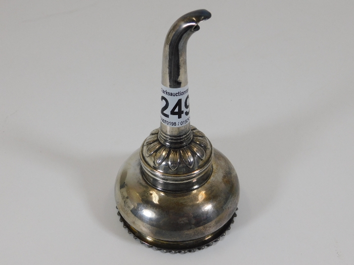 A decorative silver plated wine funnel