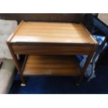 A teak two tier trolley with drawer