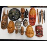 Fifteen ethnic masks & ornaments & six ethnic hardwood tools/forks