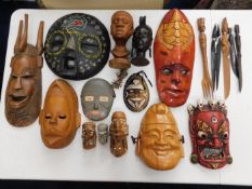 Fifteen ethnic masks & ornaments & six ethnic hardwood tools/forks