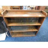 An oak bookcase with sliding glass doors