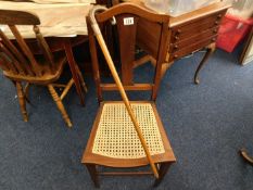 An Edwardian cane seated chair twinned with a Mala