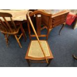 An Edwardian cane seated chair twinned with a Mala