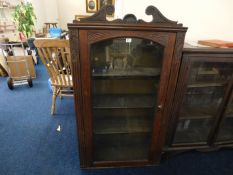 A mahogany single door bookcase