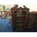 A mahogany single door bookcase