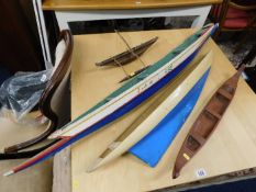 A large model rowing boat & three other model boat