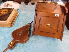 A wooden coal scuttle with a set of bellows