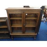 Oak two door bookcase with glass doors