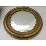 A large gilt framed mirror with convexed glass