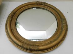 A large gilt framed mirror with convexed glass