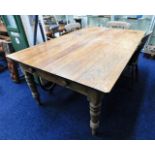 A large 19thC. pine farmhouse table with two drawe