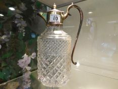 A silver plated topped claret jug