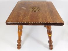 A small low level table with carved rose decor sig