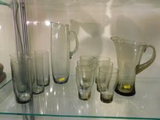 Two 1960's retro smoked glass lemonade sets, one l