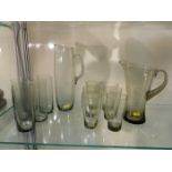 Two 1960's retro smoked glass lemonade sets, one l