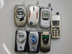 A quantity of six novelty flip phone lighters & one other