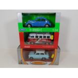 Four boxed diecast vehicles, three shown in image