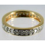 A yellow metal diamond eternity ring set with appr