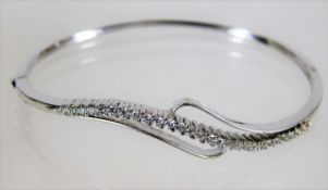 An 18ct white gold bangle set with approx. 1ct dia