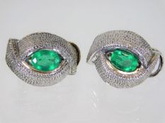 A pair of 18ct white gold earrings set with emeral
