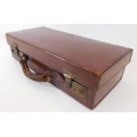 A small leather suitcase 15.75in long x 7in deep