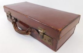 A small leather suitcase 15.75in long x 7in deep